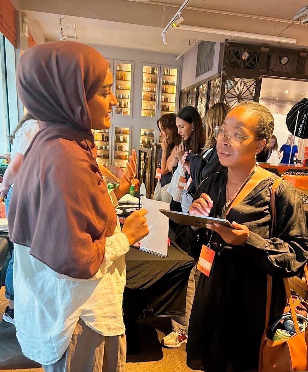 Networking conversation at a partner booth at the 2026 Women in Tech London Summit